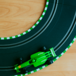 Green race car on toy car circuit. Is you business race ready? 6 marketing elements to check before starting marketing tactics. Marketing strategy. Marketing audit. Small business marketing audit. Marketing planning for small businesses and SMEs.
